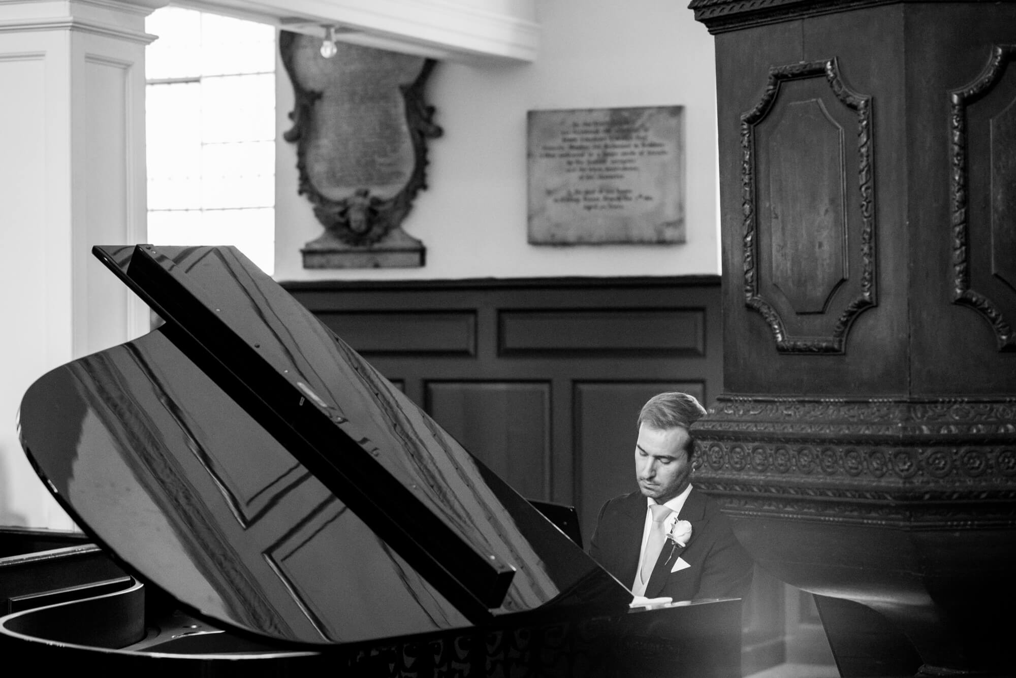 A pianist playing the piano at a wedding in the Grosvenor Chapel in London